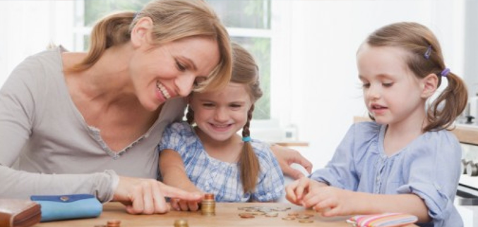 Mother with 2 daughters counting coins